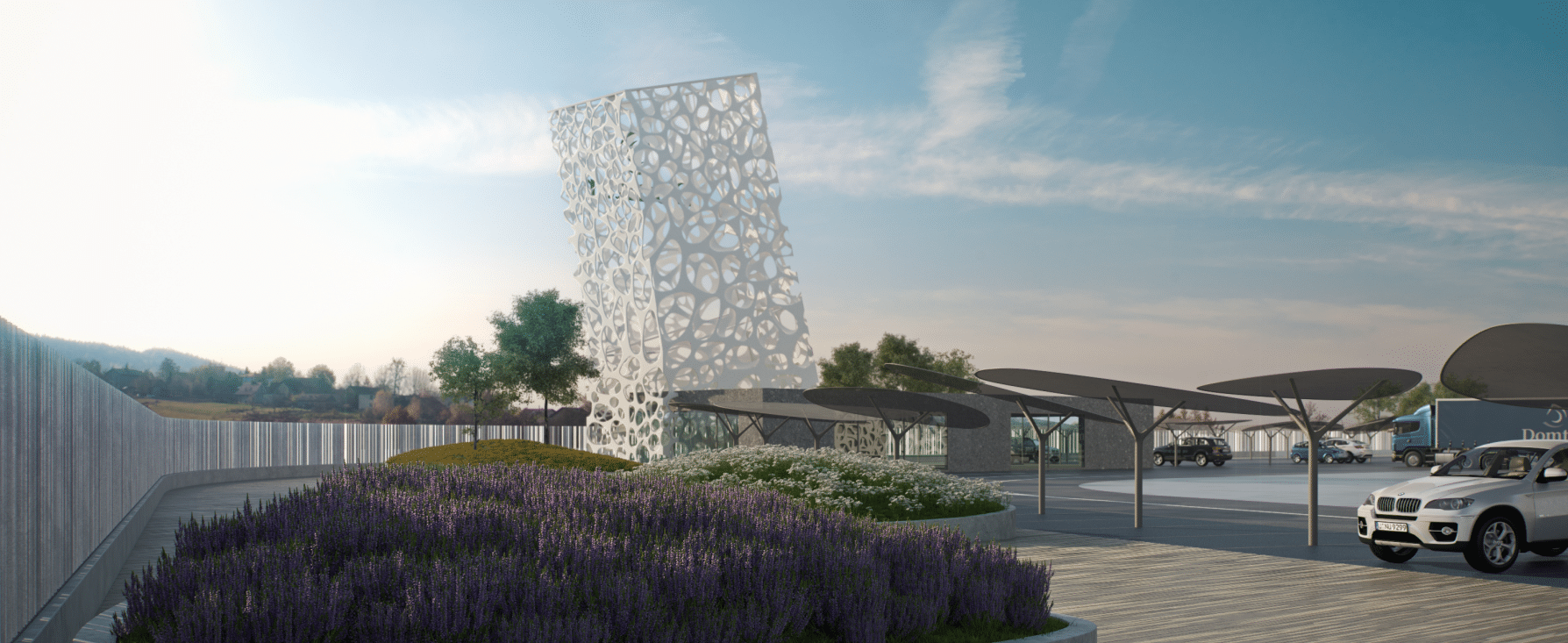 Vista del proyecto de rehabilitación de un espacio exterior en Madrid por MAM Experience Building, destacando una estructura arquitectónica moderna con un diseño perforado, áreas ajardinadas y estacionamiento con cubiertas innovadoras.