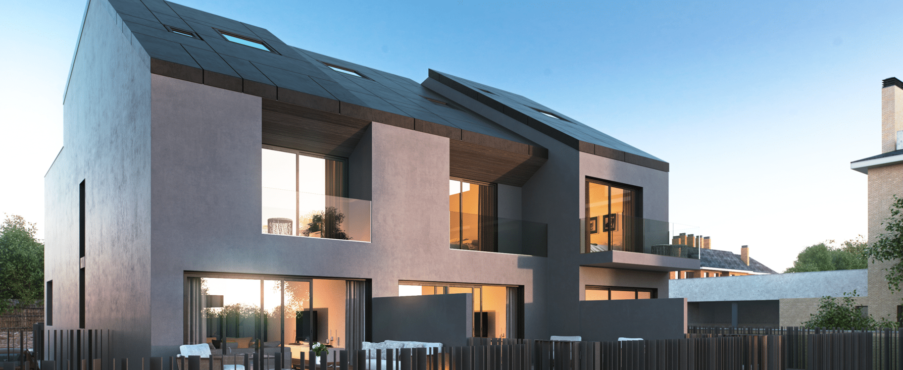 Imagen de un conjunto de viviendas adosadas con diseño moderno realizado por MAM Experience Building, mostrando grandes ventanales, balcones privados y una arquitectura contemporánea en un entorno residencial.